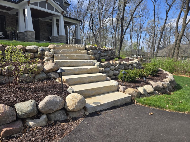 Boulder rock retaining wall with rock stepping stones Howell