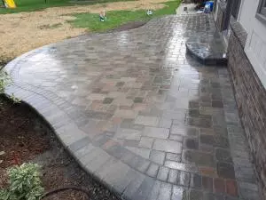 Backyard brick paver patio with entry steps