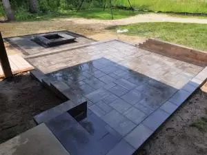 Brick paver stepping stones and patio with low profile fire pit