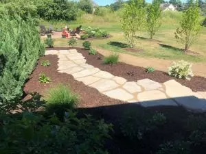 Staggered flag stone walkway with landscape planting bed
