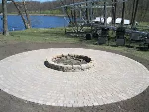 Brick fire pit on round paver patio