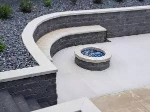 Brick natural gas fire pit on concrete patio