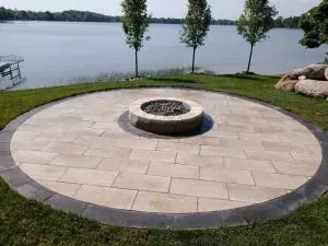 Lakeside brick natural gas fire pit on round paver patio