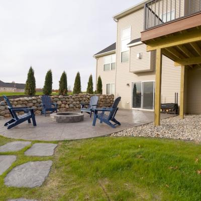 Paver patio, fire pit, and boulder retaining wall in Howell