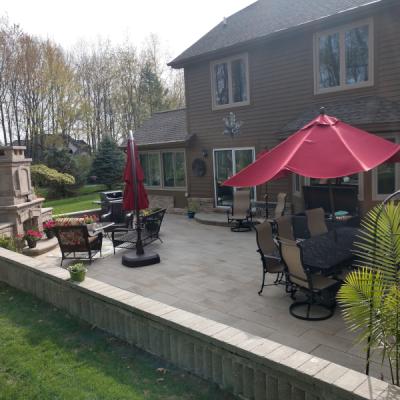 Brick seat wall with brick paver patio and custom fireplace